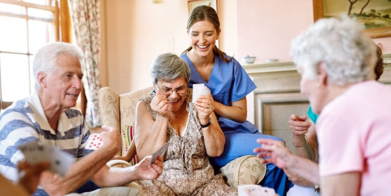 Female Nurse Building Relationship with Seniors During Activity at Assisted Living Facility