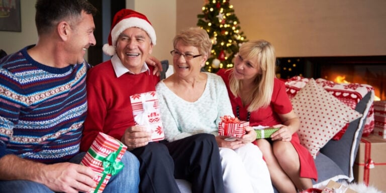 Multigenerational Family Exchanging Gifts Together at Assisted Living Facility